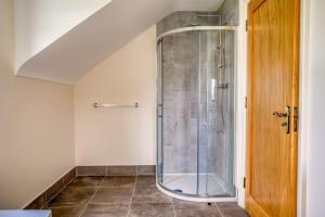 a bathroom with a shower with a glass enclosure at Teach Trà Murvagh in Mullanacross