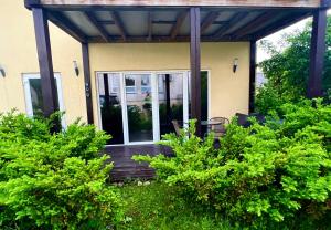 a porch of a house with glass doors at CENTRO House in Alytus