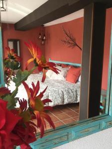 a mirror in a bedroom with a bed in it at El Balcón de Sotero y María in Prádena de Atienza