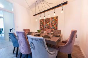 a dining room with a table and chairs at Heart of Barbican 5 bedroom 4 bathroom Boutique House with roof terrace in Plymouth