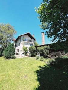 a house with a grassy yard in front of it at Pensiunea Victoria in Râşnov