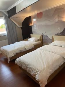 Voodi või voodid majutusasutuse Mr.Liao Hotel toas