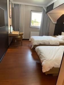 Voodi või voodid majutusasutuse Mr.Liao Hotel toas