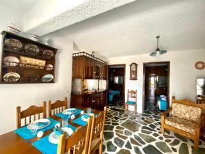 a dining room with a table and a kitchen at Gaia home in Dhragoulás