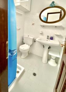 a bathroom with a toilet and a sink and a mirror at Gaia home in Dhragoulás +16 photos