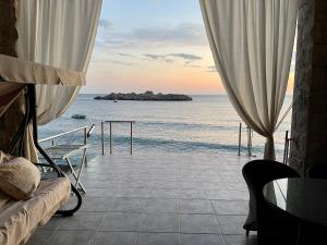 a view of the ocean from a hotel room at Apartments Lungo Mare in Sveti Stefan