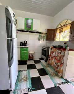 a kitchen with a black and white checkered floor at Hostel Tucupi in Soure