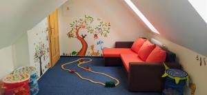 a childs room with a couch and a tree mural at Harrachovská Hacienda in Harrachov