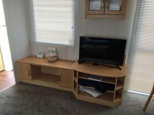 a television sitting on a desk in a room at Sea Breeze at Winthorpe Skegness in Skegness