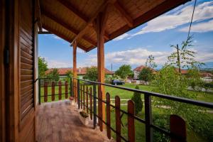 a porch of a house with a view of a field at Vila Ţara Haţegului in Haţeg