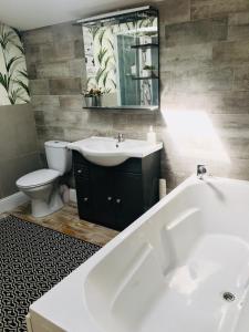 a bathroom with a tub and a sink and a toilet at L'ancienne Forge in Chéronnac +22 photos