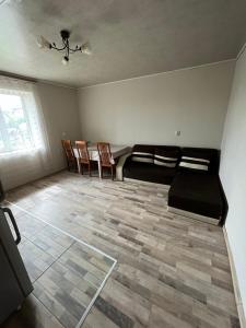 a living room with a couch and chairs in it at Вила Никови in Durankulak
