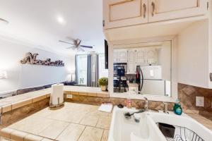 a kitchen with a sink and a refrigerator at Polk 401 in Nashville