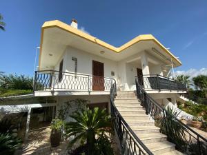 a white house with stairs leading up to it at Holiday home Mediterraneo in Marsala