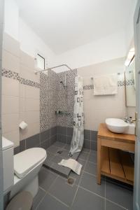 a bathroom with a toilet and a sink at Iris Apartments in Minia