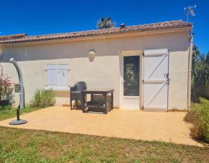 a patio with a table and chairs in front of a house at Butia in San-Giovanni