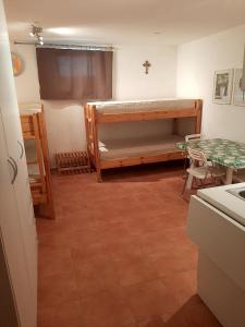 a room with a bunk bed and a table at Apartman Maja in Međugorje