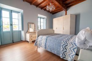 a bedroom with a bed and a mirror at Casa Amarilla Arribes in Cerezal de Peñahorcada +71 photos
