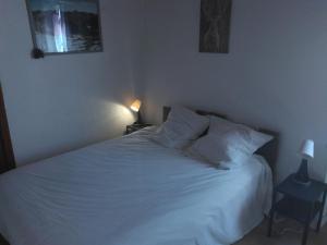 a bed with white sheets and pillows in a bedroom at Le viroulet in Valdeblore