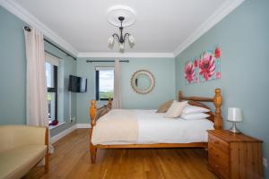 a bedroom with a bed and a couch at Fintra Beach B&B in Donegal