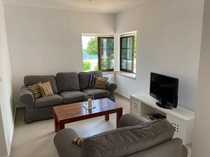 a living room with two couches and a tv at Casa Atlantico - nur einen Steinwurf vom Atlantik entfernt Ab Mai 2022 komplett neu renoviert in Los Silos