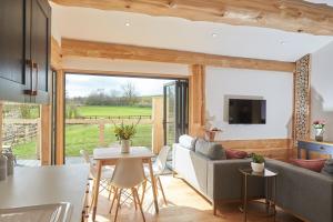 a living room with a couch and a table at Waters Edge Retreat in Naseby