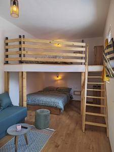 a bedroom with a bunk bed and a couch at Apartment MAIO in Viskovo