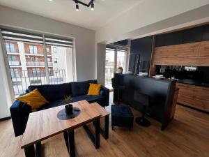 a living room with a couch and a table at Apartament Helsinki in Zator
