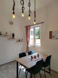 a dining room with a wooden table and chairs at Apartment MAIO in Viskovo