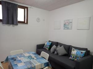 a living room with a couch and a table at Sea House Kamaraton in Marina di Camerota
