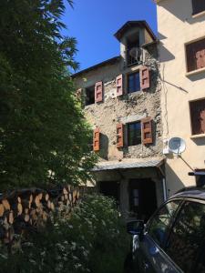 a building with windows and a car parked in front of it at La Maison du Carlit in Porté-Puymorens