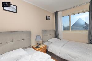 Letto o letti in una camera di Tamara Pyramids View