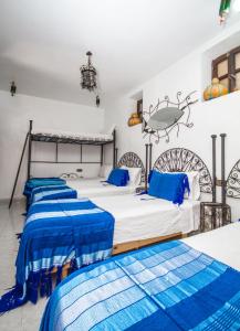 a bed room with two beds in it at Dar Touijar in Chefchaouen