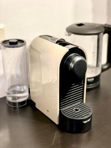 a toaster sitting on a counter next to a glass at Mini Smart Studio - Self Check-in in Graz