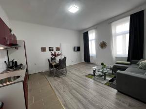 a living room with a couch and a table at Prater Tree Apartment near city centre in Vienna