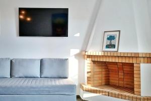 a living room with a couch and a fireplace at Sea Lilies Suites in Plaka