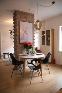 a dining room with a table and black chairs at Pink Rabbit Apart in Gdańsk