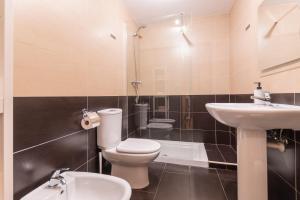 a bathroom with a toilet and a sink at Vivienda Teruel Mudejar in Teruel
