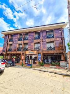 a large wooden building on the side of a street at Hotel Boutique El Mirador in Arboletes