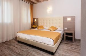 Cama ou camas em um quarto em Locanda Stravedo