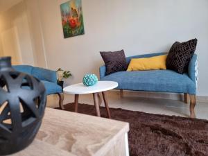 a living room with a blue couch and a table at Marfil in Posadas
