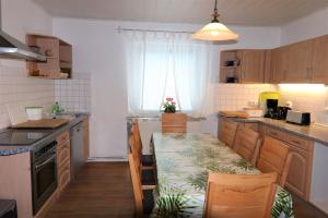 a kitchen with a table and a dining room at Landhaus Schlossblick in Sangerhausen