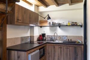 a kitchen with wooden cabinets and a sink at Quattro Domus in Heraklio