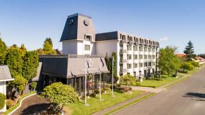 a building with a clock tower on top of it at Distinction Hotel Rotorua in Rotorua