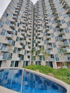 a large apartment building with a swimming pool in front of it at San José Apt with Fantastic Views, Parking and Air Conditioning in San José