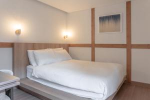 a bedroom with a large white bed and a piano at Luxury hanok with private bathtub - SW10 in Seoul