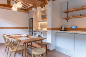 a kitchen with a wooden table and chairs at Luxury hanok with private bathtub - SW10 in Seoul