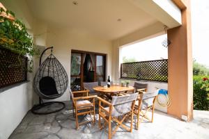 a patio with a wooden table and chairs at Perfect House in Pefkochori