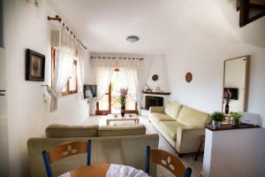 a living room with a couch and a table at Perfect House in Pefkochori