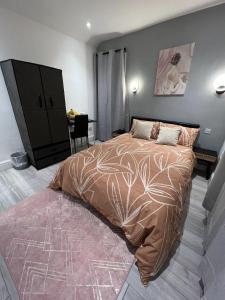 a bedroom with a large bed and a desk at Welsh Homestay in Pembroke Dock